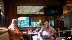 FILE - People wait for their breakfast at a local diner, Sept. 4, 2020, in Hoboken, N.J. Gov. Phil Murphy gave the go-ahead Monday for indoor dining not to exceed 25% of capacity, in light of coronavirus transmission precautions.