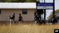 Law enforcement officials investigate the scene of a shooting at the First Baptist Church of Sutherland Springs, Nov. 6, 2017, in Sutherland Springs, Texas. 