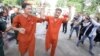 Ny Sokha, left, and Nay Vanda, right, two senior human rights monitoring officers from ADHOC, are escorted by police to the Supreme Court, Phnom Penh, Cambodia, November 23, 2016. (Leng Len/VOA Khmer