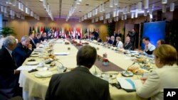 German Chancellor Angela Merkel, right, joins other EU leaders for a breakfast meeting during an EU summit in Brussels, Oct. 20, 2017. 