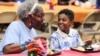 FILE - Third grader Dallin Curry, 8, talks with his grandmother Mary Durr on Sept. 6, 2024, during a Grandparents Day celebration in the lunchroom at Burns Elementary School in Owensboro, Ky. 