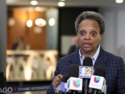 FILE - In this March 15, 2020 file photo, Chicago Mayor Lori Lightfoot speaks to reporters at O'Hare International Airport in Chicago.