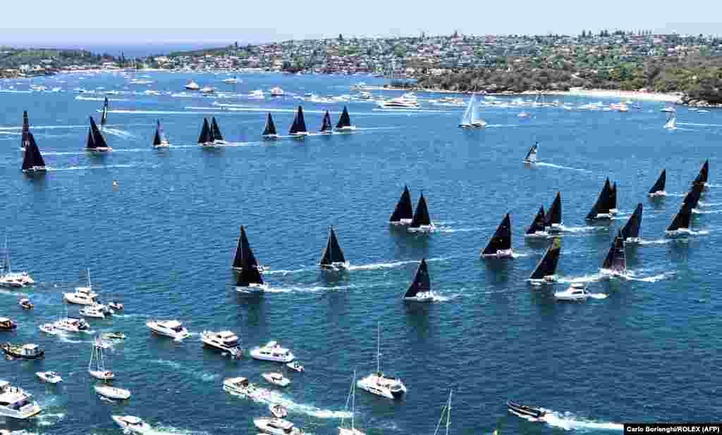 This handout image taken and received from Rolex shows yachts competing at the start of the annual Sydney to Hobart yacht race on Boxing Day on Sydney Harbor, Australia.&nbsp;(Photo by Carlo Borlenghi / ROLEX / AFP) / RESTRICTED TO EDITORIAL USE - STRICTLY NO COMMERCIAL USE -