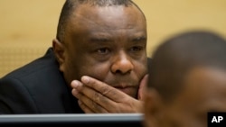 Former Congo vice-president Jean-Pierre Bemba looks up at his trial at the International Criminal Court in The Hague, Netherlands, Sept. 29, 2015.