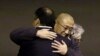 FILE - Kenneth Bae, center, who had been held in North Korea since 2012, is hugged after arriving at Joint Base Lewis-McChord, Washington, Nov. 8, 2014.