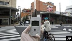 A Greenpeace radiation expert monitors the radiation near Namie village, 40 kms from the stricken Fukushima Dai-Ichi nuclear plant, April 8, 2011