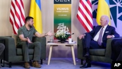 Presiden AS Joe Biden (kanan) berbicara dengan Presiden Ukraina Volodymyr Zelenskyy di sela-sela KTT NATO di Vilnius, Lithuania 12 Juli 2023. 