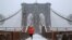 A man runs over the Brooklyn Bridge during morning snow in Manhattan, New York City, Dec. 17, 2016. 