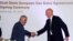 Rovnag Abdullayev (L), the president of Azerbaijan's 'Shah Deniz,' shakes hands with Gianfilippo Mancini, director of the Market Division of the Enel Group, Italy's national electric company, during a signing ceremony in Baku, on September 19, 2013.