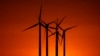 FILE - Wind turbines are silhouetted against the setting sun at the Spearville Wind Farm, Sept. 29, 2024, near Spearville, Kansas.