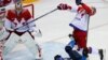 Lauri Korpikoski (28) dari Finlandia memukul Alexei Yemelin dari Rusia (kanan) seraya penjaga gawang dari Rusia, Semyon Varmalov mengikuti arah bola pada babak kedua babak perempat final hoki es. Finlandia menang 3-1. &nbsp;