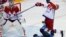 Finland's Lauri Korpikoski (28) hits Russia's Alexei Yemelin (right) as Russia's goalie Semyon Varlamov follows the puck during the second period of their men's quarter-final ice hockey game, Sochi, Feb. 19, 2014. 