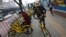 FILE - In this March 21, 2017 photo, commuters use bicycles from bike-sharing company Ofo placed on the sidewalk in Beijing, China. Using shared bikes, thousands of university students rode overnight from Zhengzhou, the largest city in Henan province, to Kaifeng.
