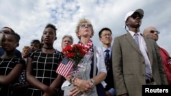 People watch as U.S. President Barack Obama, Defense Secretary Ash Carter and Joint Chiefs Chair Gen. Joseph Dunford take part in a ceremony marking the 15th anniversary of the 9/11 attacks at the Pentagon in Washington, U.S., Sept. 11, 2016. 