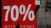 A man wearing a face mask walks past a closed shop advertising a sale, on Oxford Street in London, as the country is in lockdown to help curb the spread of the coronavirus, April 15, 2020.