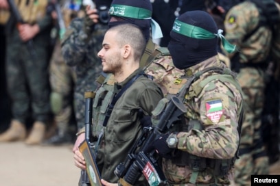 Omer Wenkert, a hostage held in Gaza since Hamas’ deadly Oct. 7, 2023, attack on Israel, is escorted by Hamas militants as he is released in Nuseirat, Gaza Strip, on Feb. 22, 2025.