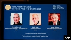 FILE - A tablet shows this year's laureates US Chemist Moungi Bawendi, US Chemist Louis Brus and Russian physicist Alexei Ekimov during the announcement of the winners of the 2023 Nobel Prize in chemistry at Royal Swedish Academy of Sciences in Stockholm.