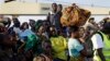 In this image taken May 23, 2015, refugees who fled Burundi's violence and political tension arrive in Kigoma, Tanzania, after making the journey on Lake Tanganyika. 