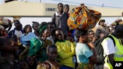 In this image taken May 23, 2015, refugees who fled Burundi's violence and political tension arrive in Kigoma, Tanzania, after making the journey on Lake Tanganyika. 