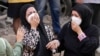 Women react in front of their destroyed apartment at the site an Israeli airstrike in Beirut, Lebanon, Oct. 11, 2024. 