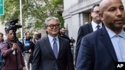 Bill Hwang, founder of Archegos Capital Management, center, leaves Manhattan federal court after the first day of his corruption trial, May, 13, 2024, in New York.