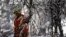 A Toronto Hydro worker tries to restore power, behind frozen tree branches, in the Scarborough suburb after an ice storm in Ontario, Canada. Over 30,000 residents have been left without power since the storm hit on Dec. 22, local media reported.