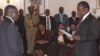 FILE: Emmerson Mnangagwa, right, is sworn in as Vice President by Zimbabwean President Robert Mugabe at State House in Harare, Friday, Dec, 12, 2014. Mnangagwa was sworn in following a cabinet reshuffle that saw former deputy President Joice Mujuru dismissed from her post over allegations that she plotted to remove Zimbabwean President Robert Mugabe from power.( AP Photo/Tsvangirayi Mukwazhi)