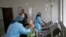 FILE - A girl, center, suspected of being infected with cholera, is treated at a hospital in Sanaa, Yemen, Sept. 9, 2019.