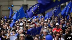 FILE - Hundreds of people attend a rally of the Pulse of Europe movement in Berlin, May 7, 2017. Pulse of Europe goes to the streets equipped with the symbols of Europe to demonstrate for a united Europe.