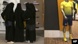 FILE - Saudi women shop at a mall in Riyadh, Saudi Arabia, Dec. 11, 2015. 