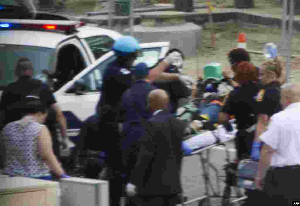 Capitol Police and medics take a shooting victim away on a stretcher at the site of a shooting on Capitol Hill.