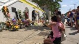 Mourners comfort each other in front of the Emanuel African Methodist Episcopal Church in Charleston, S.C., two days after a shooting left nine dead.
