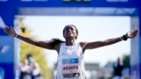 Ethiopia's Tigist Assefa celebrates as she crosses the finish line to win the women's division of the Berlin Marathon in world record time in Berlin, Germany, Sunday, Sept. 24, 2023. (AP Photo/Markus Schreiber)
