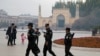 Uighur security personnel patrol near the Id Kah Mosque in Kashgar in western China's Xinjiang region on November 4, 2017.(AP Photo/Ng Han Guan, File)