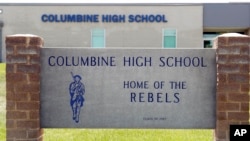 Signs outside Columbine High School, June 13, 2019, in Littleton, Colo. The school district was considering the demolition of Columbine, the scene of a mass assault more than 20 years ago, and rebuilding the current school. 