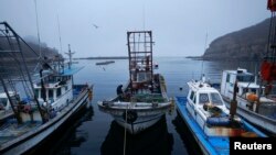 FILE - A fisherman sits on his boat in a small port on the island of Baengnyeong.