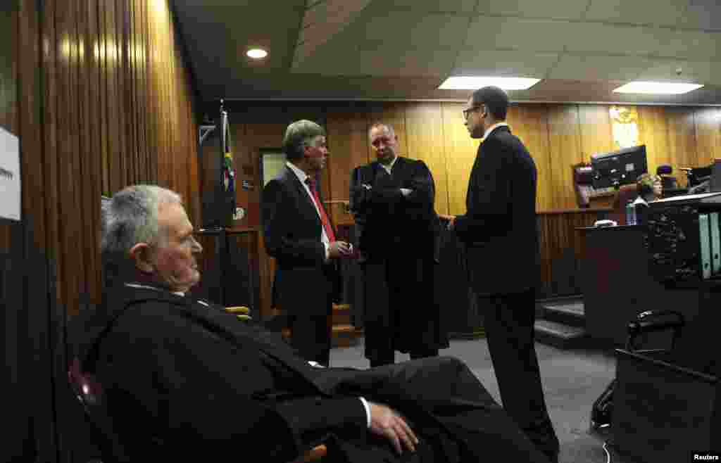 Oscar Pistorius (right) with his defense team Barry Roux (foreground), Brian Webber (left) and Kenny Oldwage (center) before the closing arguments, in the North Gauteng High Court, in Pretoria, Aug. 7, 2014.