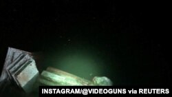 The statue of Christopher Columbus is seen in a lake after it was pulled down by protesters in Richmond, Virginia, June 9, 2020, in this picture obtained from social, June 9, 2020. (Instagram/@Videoguns)