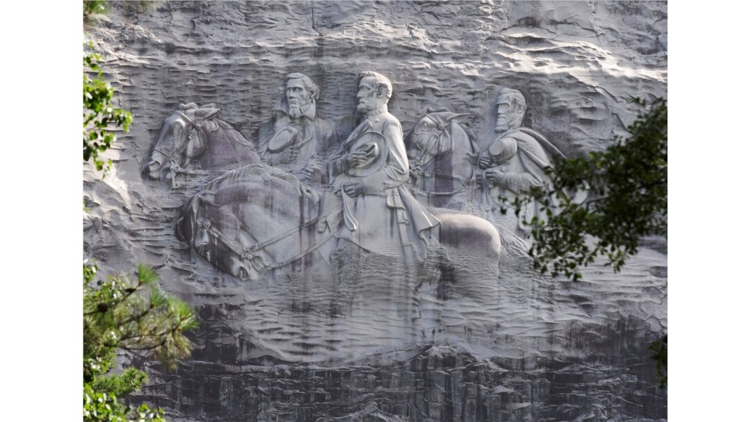 FILE - A carving in Stone Mountain, Georgia, depicting Confederate leaders Stonewall Jackson, Robert E. Lee and Jefferson Davis, is America's largest Confederate memorial.