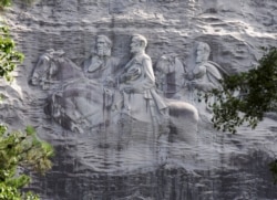 FILE - A carving in Stone Mountain, Georgia, depicting Confederate leaders Stonewall Jackson, Robert E. Lee and Jefferson Davis, is America's largest Confederate memorial.