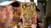 A woman holds a hand-made "Yes" sign as supporters gather at the Redfern Community Centre in Sydney, Oct. 9, 2023. Australians appear likely to reject the creation of an advocate for the Indigenous population in a referendum outcome that some see as a victory for racism.