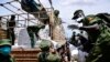 Members of Local Defense Unit (LDU) unload relief food to civilians who are affected by the lockdown to prevent the potential spread of coronavirus, in Kampala, Uganda, April 4, 2020. 