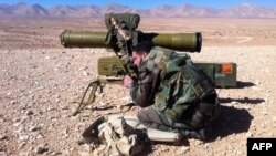 A pro-regime soldier aims a rocket launcher towards rebel locations in the Qalamoun region on the outskirts of the Syrian capital Damascus, Feb. 13, 2014. 