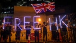 Demonstrators wave a British flag during a rally outside of the British Consulate in Hong Kong, Oct. 23, 2019.