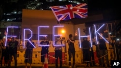 Demonstrators wave a British flag during a rally outside of the British Consulate in Hong Kong, Oct. 23, 2019.