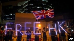 Demonstrators wave a British flag during a rally outside of the British Consulate in Hong Kong, Oct. 23, 2019. 