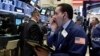 Trader Tommy Kalikas works on the floor of the New York Stock Exchange, March 30, 2017. 