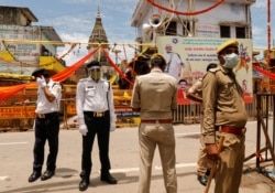 Policemen stand guard before the arrival of India's Prime Minister Narendra Modi ahead of the foundation laying ceremony for a Hindu temple in Ayodhya, India, Aug. 5, 2020.