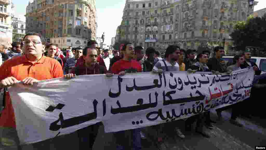 Anti-government protesters shout slogans against a new law in Egypt that restricts demonstrations, in downtown Cairo, Nov. 26, 2013.