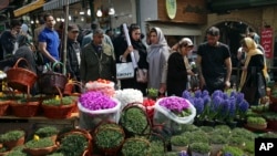 Iranians shop for hyacinths, garlic, sprouts and other items used to celebrate the Iranian New in northern Tehran. (March 19, 2018.)